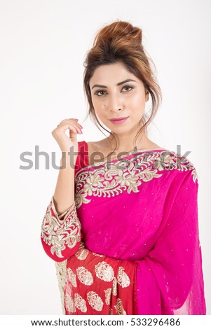 Beautiful indian girl in traditional dress on white background