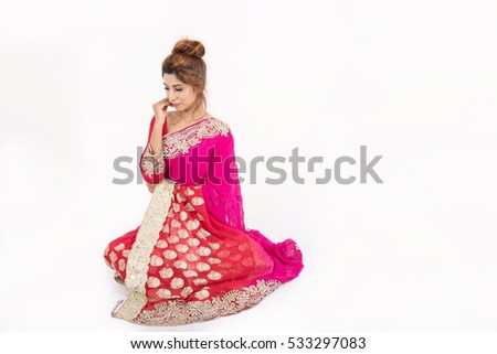 Beautiful indian girl in traditional dress on white background