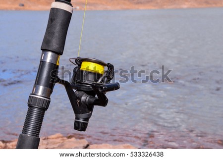 Conceptual Photo Picture Fishing with rod on a lake