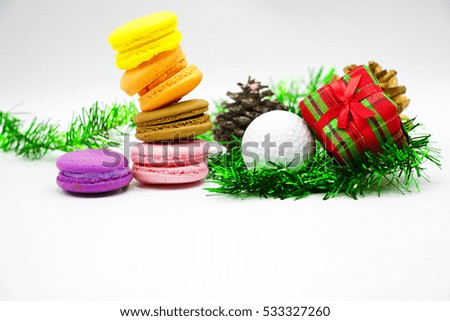 Golf ball and macaron with Christmas present on white background