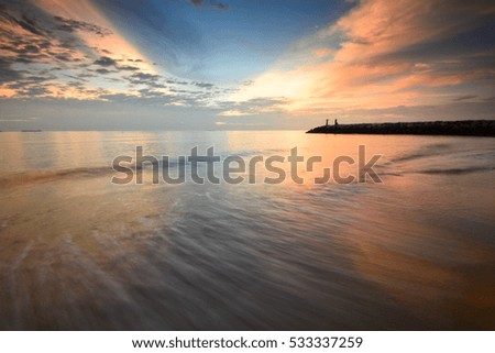 Beautiful twilight sky scenery at seascape. Motion blur on foreground or wave due to slow shutter speed shot. Composition of nature.