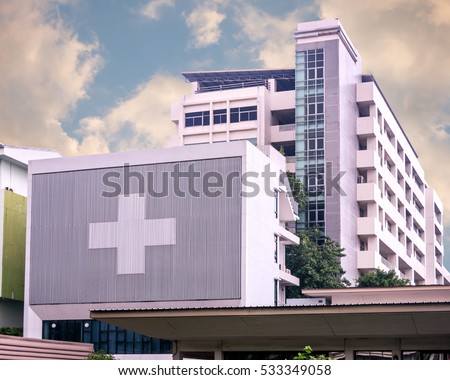 hospital building with big symbolic at cloudy day