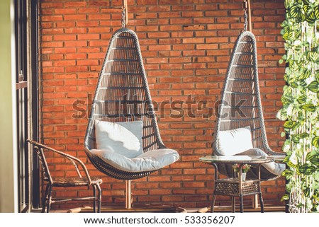 Outdoor hanging chair in balcony vintage style tone 