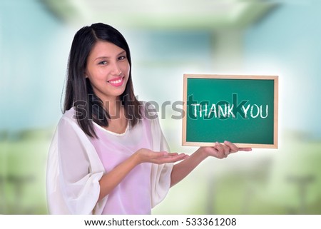 Young Women holding chalkboard with text Thank You