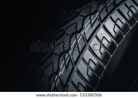 Clean Tyre, black new shiny car tire background Royalty-Free Stock Photo #533380306