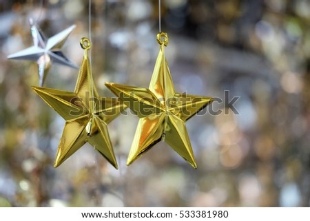 Christmas gold stars for christmas night on the background as bokeh.