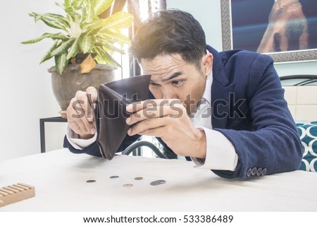 Businessman well-dressed with empty wallet-broke Royalty-Free Stock Photo #533386489