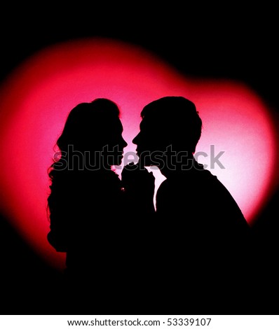 silhouette of man and woman on the red heart
