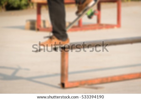 Defocused and blurred image for background of boy skating on skateboard in skate park 