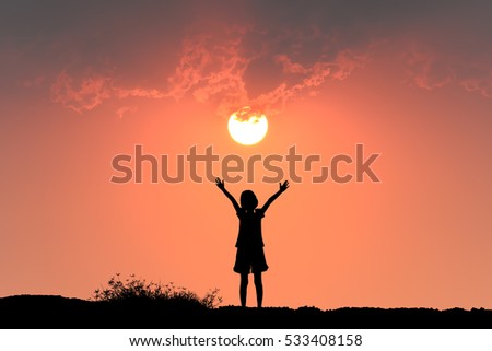  Silhouette of freedom girl in sunset background.