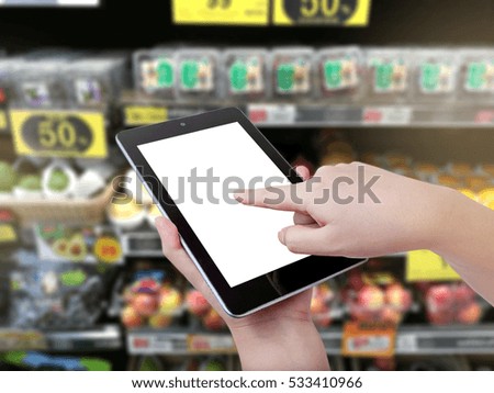 hand hold and touch screen smart phone, tablet,cellphone on Shopping mall blur background .blurry backgrounds