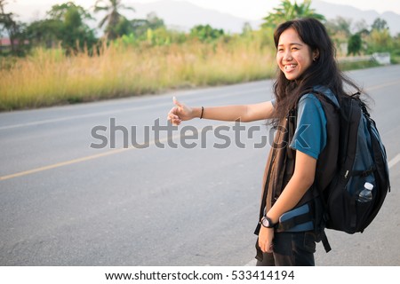 Teen girl Hitchhiker near road coutyside.