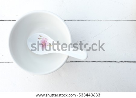 Top view of Empty bowl with spoon on wooden table background