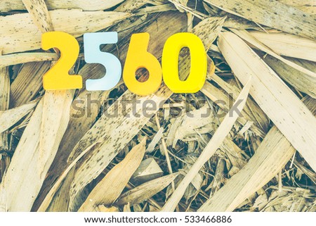Wooden number of 2560 on bamboo leaves for THAILAND new year celebrations