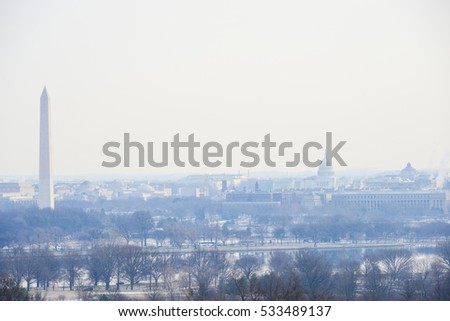 Washington DC skyline with Washington Monument, United States Capitol building, and Potomac River in winter.