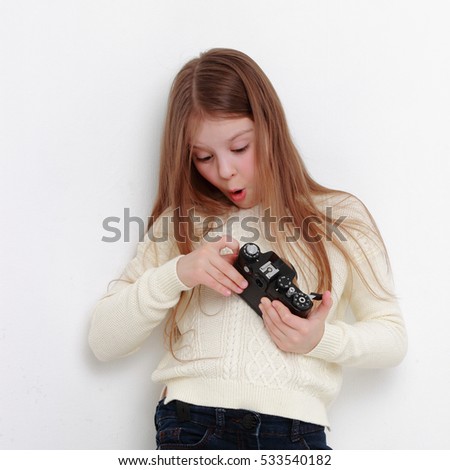 Teen girl holding photo camera and taking pictures