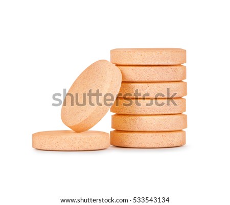close up of vitamins or pills stack isolated on white background