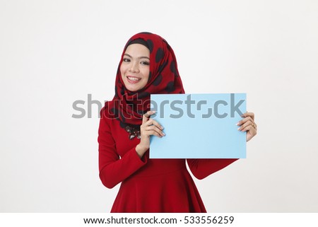 hijab with red tudung holding a paper cardboard