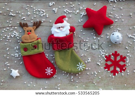 Christmas socks and Christmas decoration on white wooden background, flat laying in top view