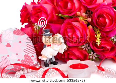 Red roses, bride and fiance, candle and gift box close up picture.
