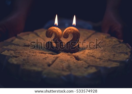 Celebrating birthday. Birthday cake with candles number 32.
