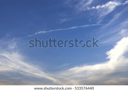 The long line of Jet engine cloud on beautiful blue sky.