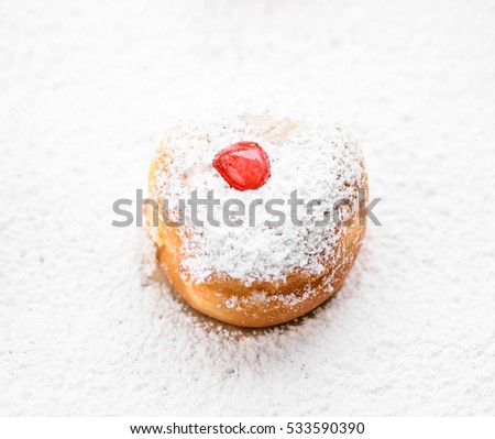 Donut on a white sugar powder background. Top view image of jewish holiday Hanukkah sweet. Closeup 

