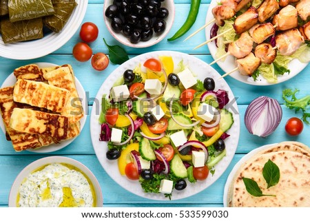 Greek food mix on a blue wooden background. Top view. 