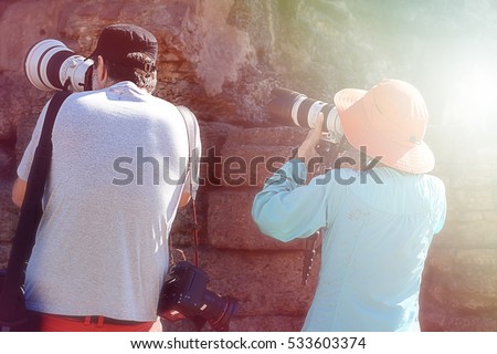 Professional photographer from back taking picture with soft focus,fill color filter pastel gradient tone,photographer camera dslr photo portrait photographing photography taking concept -stock image 