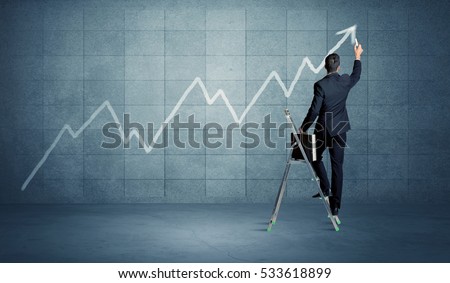 A man standing on a ladder and drawing a chart on blue wall background with exponential progressing curve, line Royalty-Free Stock Photo #533618899