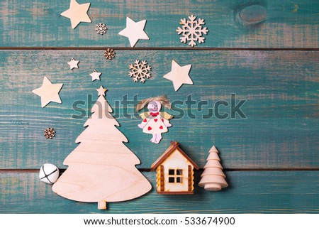 Christmas angel and star Shine on the Christmas tree and wooden house . 