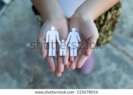 Children hands holding small model of heart and family , concept family