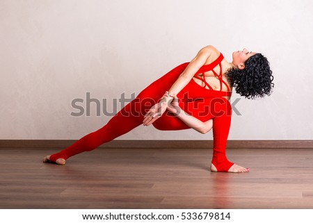 Pretty woman practicing yoga at home