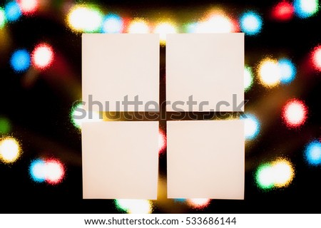 four note papers on christmas bokeh background