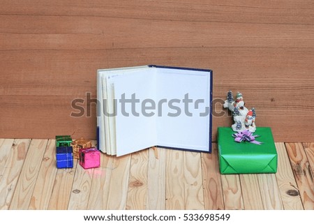 Christmas day with snowman gift  happy new year  on  wooden background