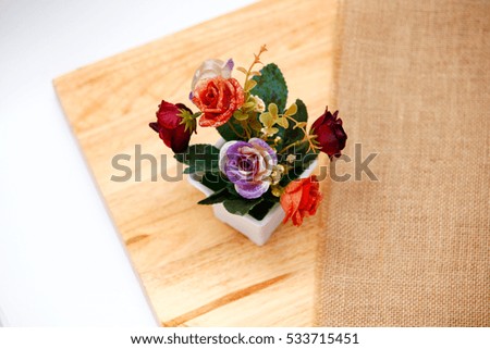 Flowers,red,orange,purple,flowerpot,Roses in pots placed on a wooden floor.