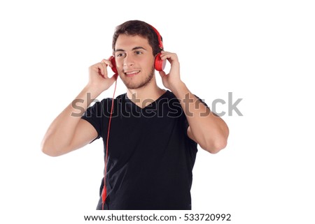 Close up of a young handsome man listening music with red headphones. Isolated white background.