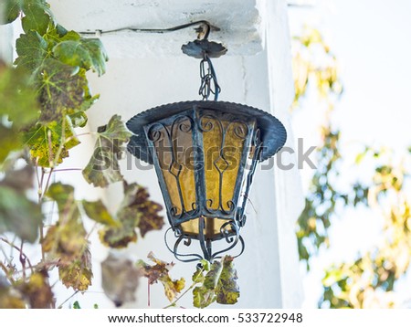 Lantern on the wall on a village house in Spain