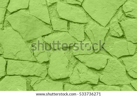 Greenery pantone color of the year. Texture of coarse patterned stone irregularly shaped closeup Royalty-Free Stock Photo #533736271