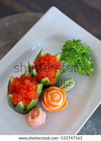 Red caviar in decorated cucumber. 