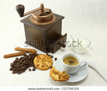coffee beans  grinder and hot cup of  on white background