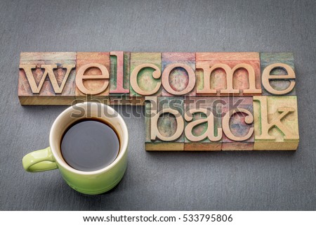 Welcome back sign - text in letterpress wood type with a cup of coffee