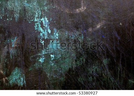 A dark green surface with stains and paint marks