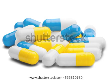pile of medical pills blue and yellow color on a isolated white background Royalty-Free Stock Photo #533810980
