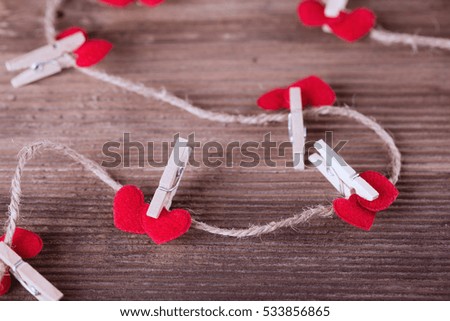 Red textile hearts connected by clothespin. Love concept. 
