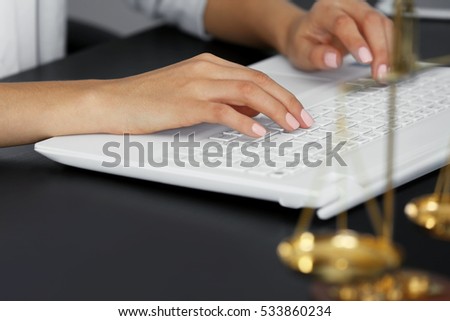 Woman working with laptop in modern office