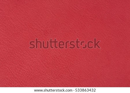Bright red leather texture, abstract background. High resolution photo.