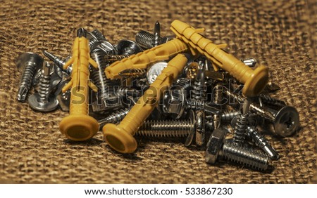 metal screws on a background of burlap