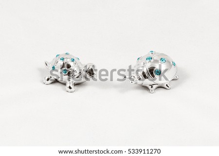 Ornamental silver turtle and ladybird with gemstones, isolated on white background