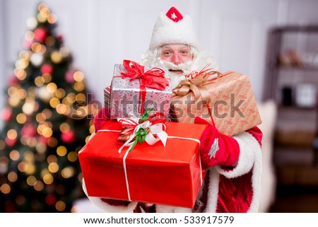 Santa Claus with gifts. Blured background